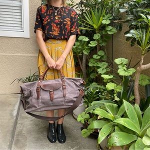 Grayish brown cotton/leather travel bag